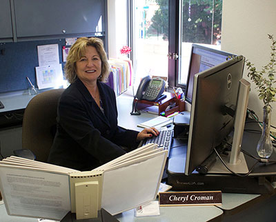Cheryl Croman sits behind her desk in the department office