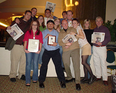 Group photo from 2003 of news students with Professor Dave Waddell after winning an award for The Orion